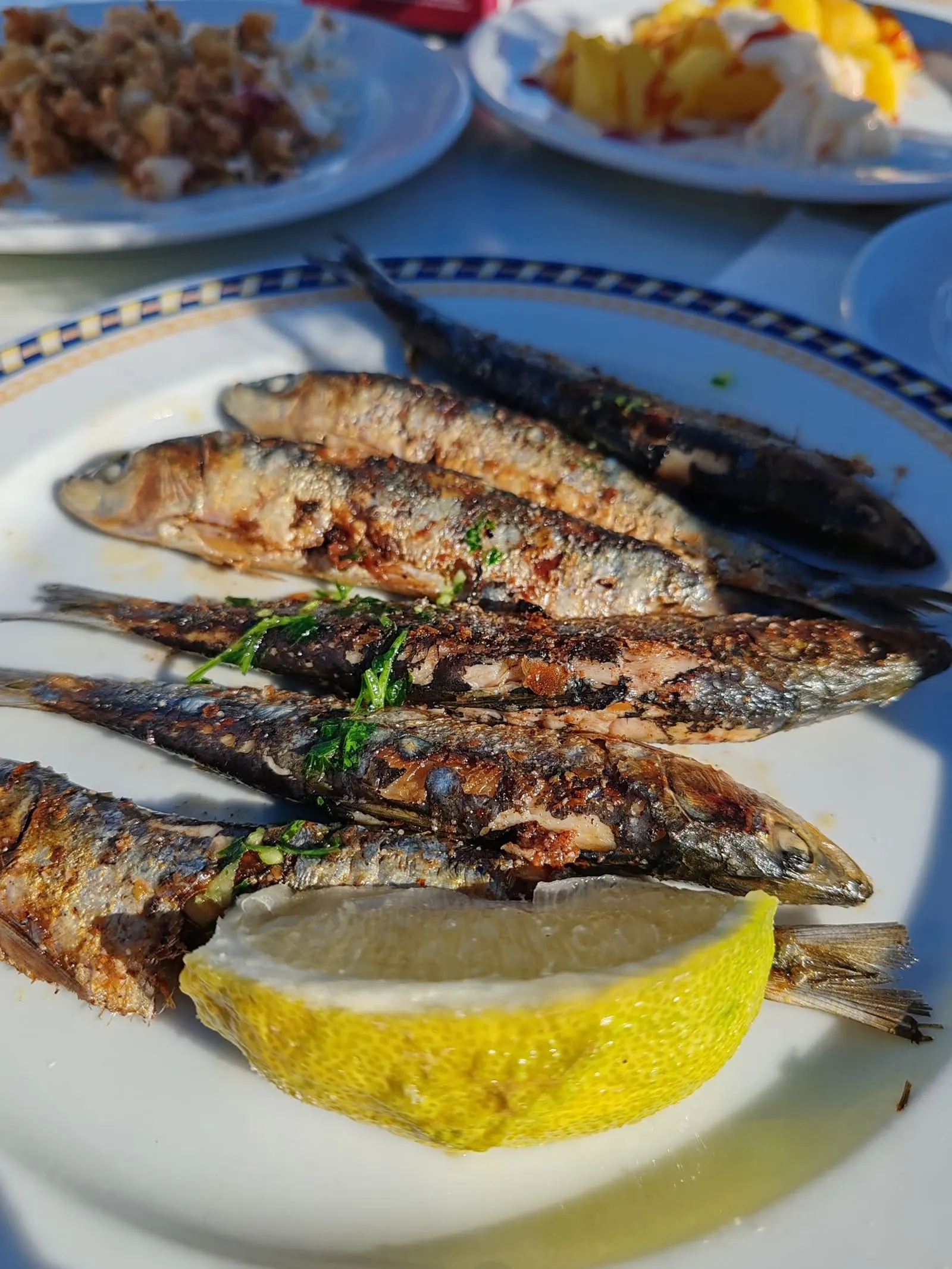 Grilled sardines garnished with lemon